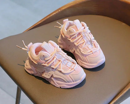 Overhead shot of two pairs of children's plush waterproof sneakers, one for a boy, one for a girl