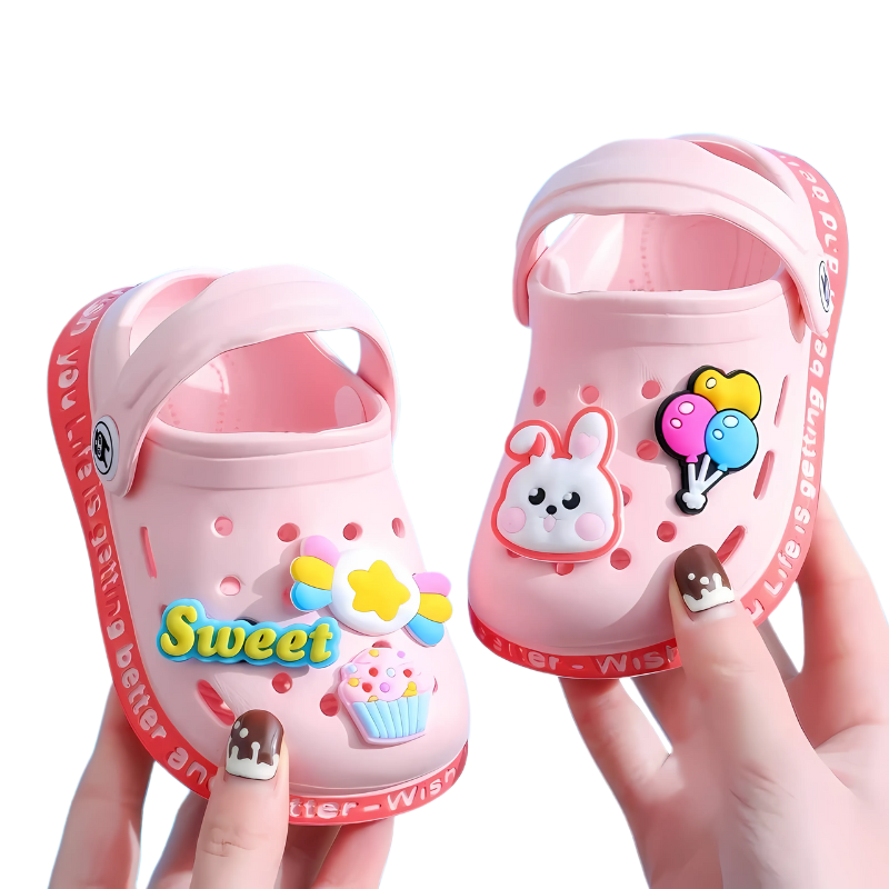 Toddler in colorful slip-on clogs playing outdoors, highlighting the lightweight and practical design