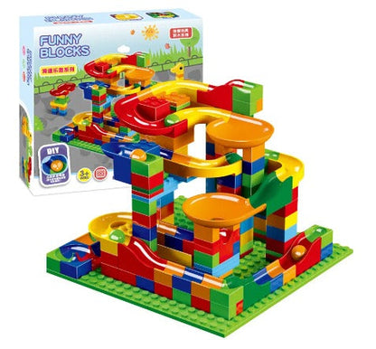 Child's hands excitedly placing a marble into a newly built marble run track, engaging developmental and educational toy
