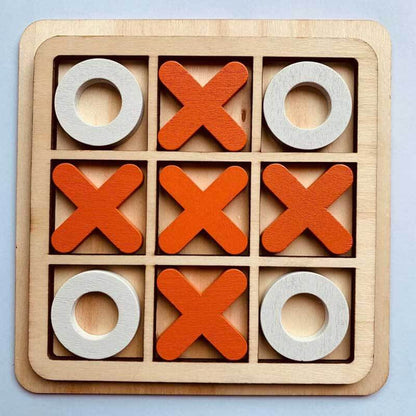 A child playing with a wooden Tic Tac Toe game, demonstrating the engaging and classic appeal of this board game.