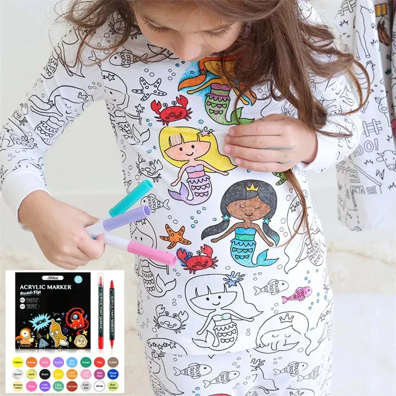 Child wearing white Kids DIY Coloring Pajama Set, actively coloring with included markers