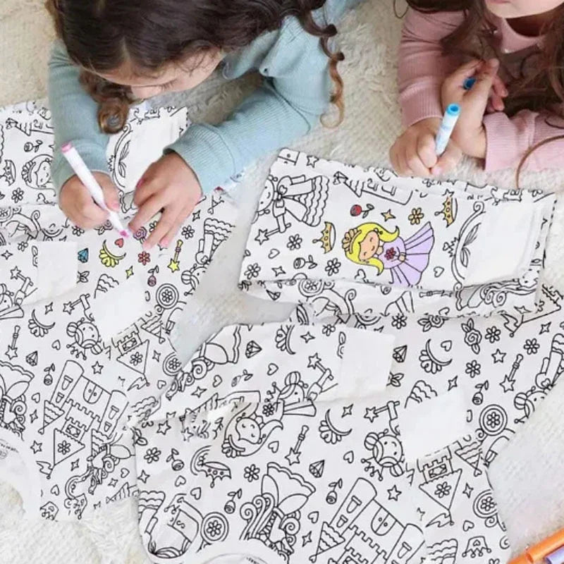 Close-up of a child's hand coloring a design on a Kids DIY Coloring Pajama Set, creative play