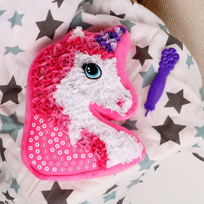 Unicorn throw pillow craft kit with soft plush materials for children to assemble themselves.