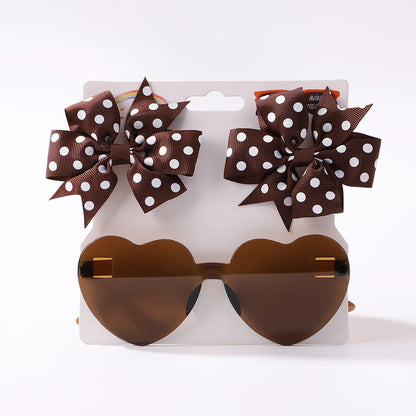 Tabletop display of the Kids Dot & Heart Sunglasses Hairpin Set, ready for gifting