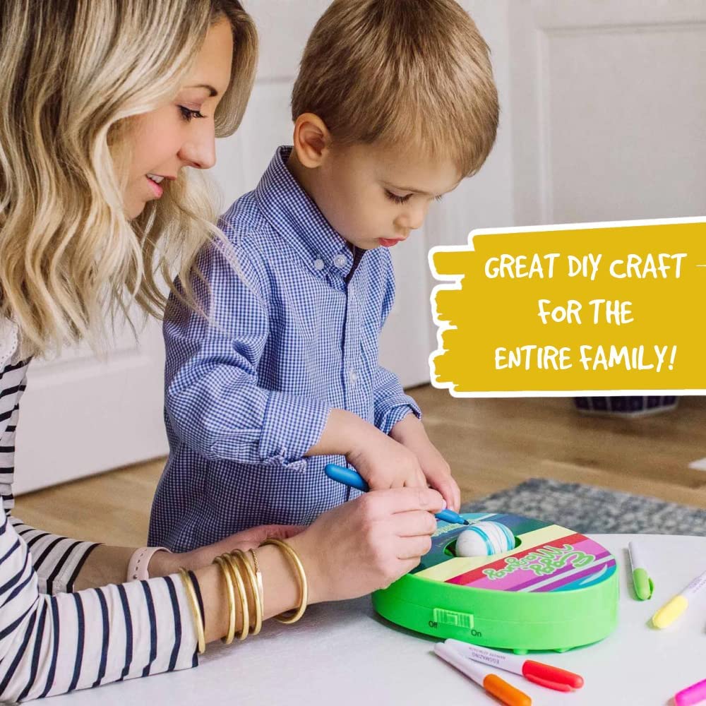 Easter egg decorating station with a blue spinner, instruction manual, and multiple colored pens.