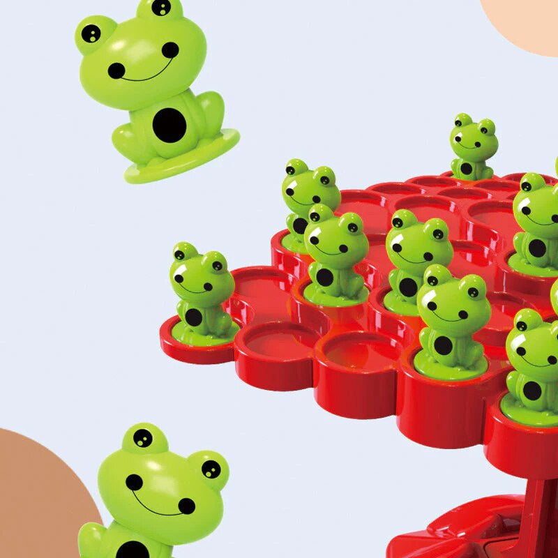Preschooler stacking frogs on the Frog Tree Balance Game, learning balance and counting.