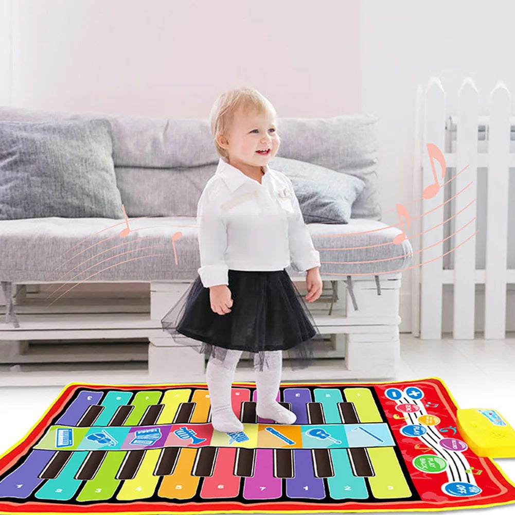 Close-up of a hand pressing a musical note on a kids' interactive play mat, learning music
