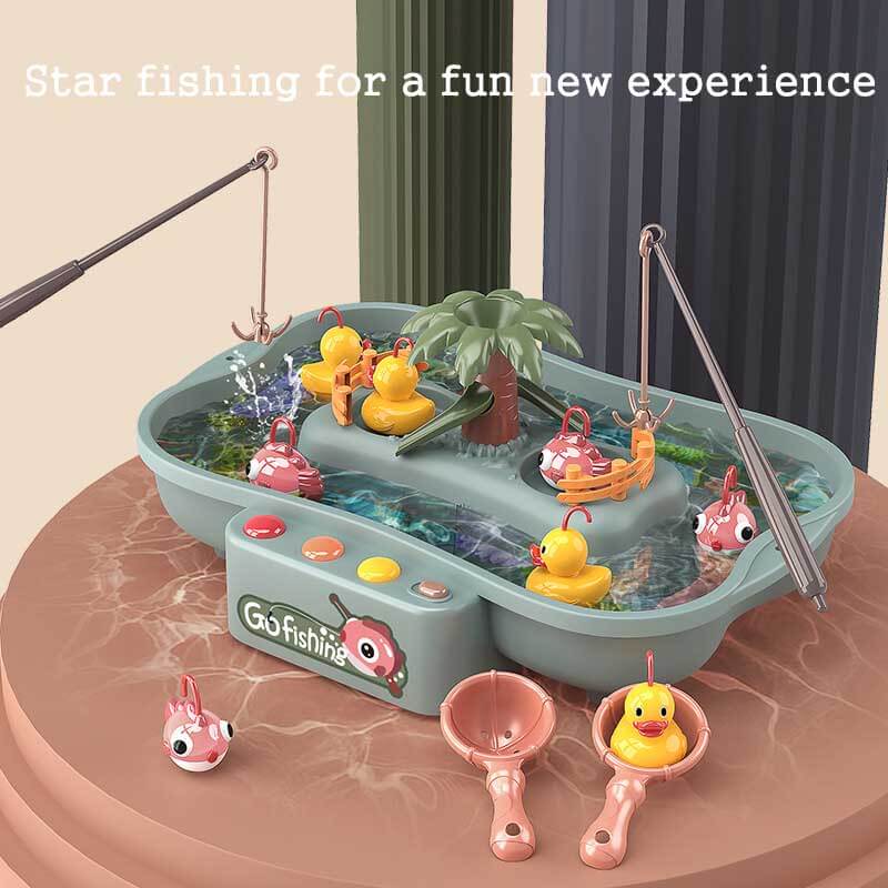 Close-up of child's hand catching a fish from a musical electronic fishing game with slideway