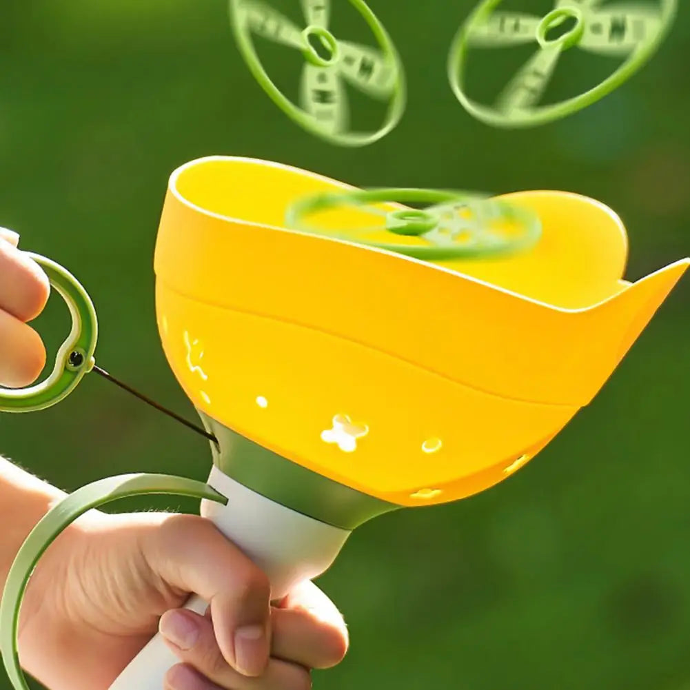 Child's hand holding a Flying Disc Launcher, preparing to launch a colorful frisbee