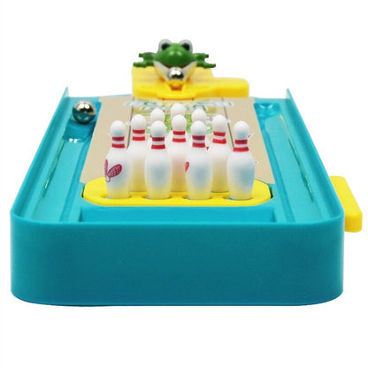 Child happily knocking down frog bowling pins, improving coordination, indoor game