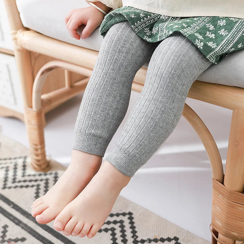 Detail of elastic waistband on kids cotton blend leggings, ensures snug fit