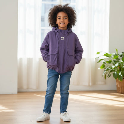Toddler in yellow hooded windbreaker jacket, playing outdoors, perfect for wind