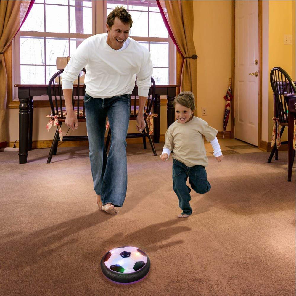 A child joyfully kicking an Air Hover Soccer Ball, highlighting the fun and active nature of the indoor game.