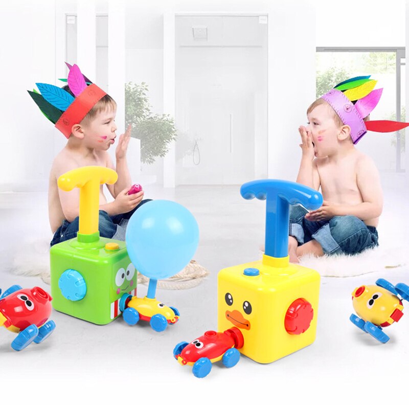 Child inserting a balloon into a green inertia car toy, teaching physics through play