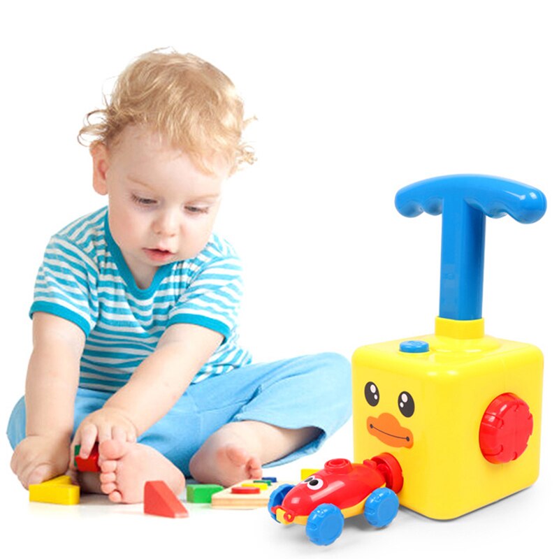 Close-up of a yellow balloon powered inertia car, durable plastic toy for active play