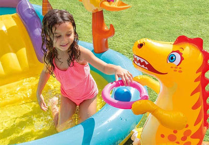 An empty inflatable dinosaur sprinkler pool, ready for kids' summer outdoor fun in the backyard.