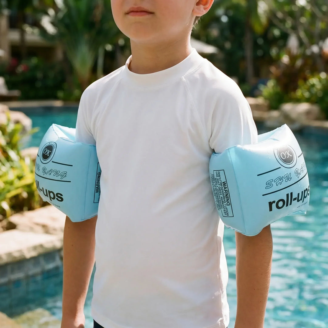 Kids' inflatable swimming armbands with cartoon designs for pool fun & water safety.