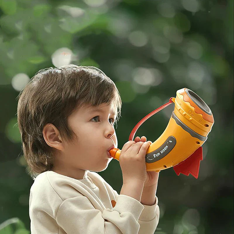 Close-up of a child's hand pressing a button on the Animal Sounds Learning Toy, bright colors