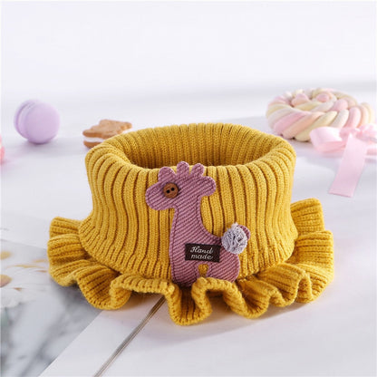 Close-up of a child's knitted bib with delicate lace trim, a versatile neck warmer