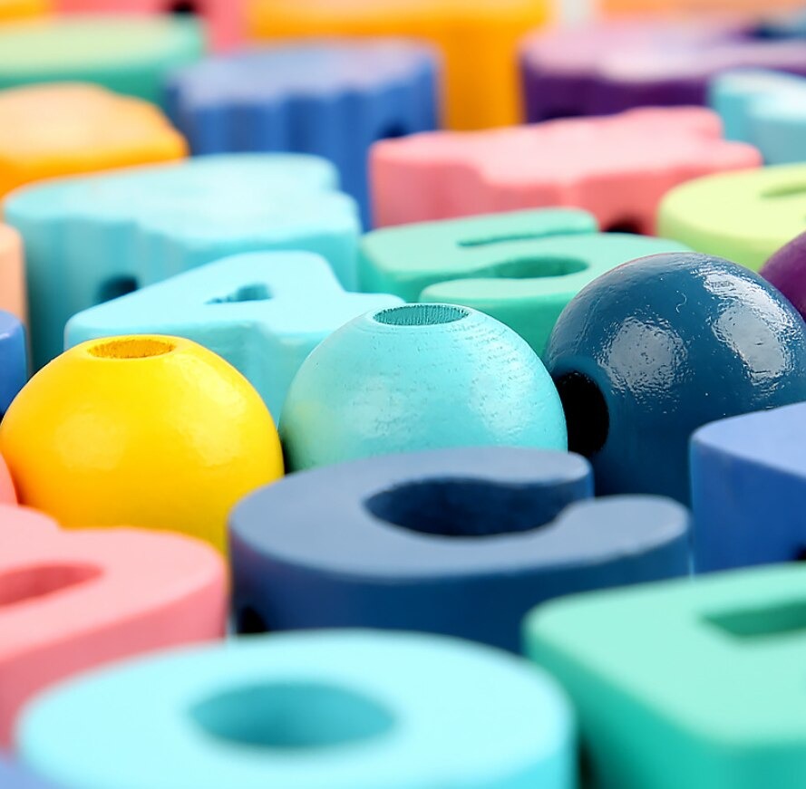 Educational lacing beads game for kids, promoting fine motor skill development and creative play with wooden toys.