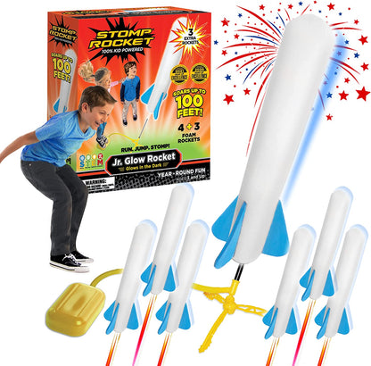 Kids launching a red foam rocket from a green Air Power Rocket Launcher toy set outdoors