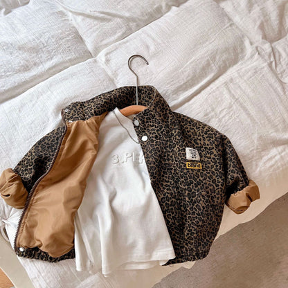 Close-up of leopard print cotton fabric on kids' zip-up jacket, winter coat material