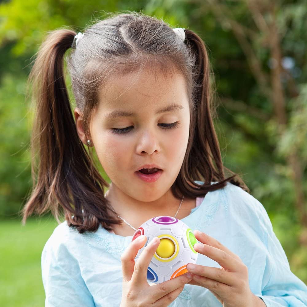 Toddler holding a vibrant ABS plastic educational puzzle ball, enhancing fine motor and cognitive skills