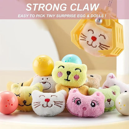 Girl happily playing with a pink kids' mini claw machine, focused on grabbing a prize