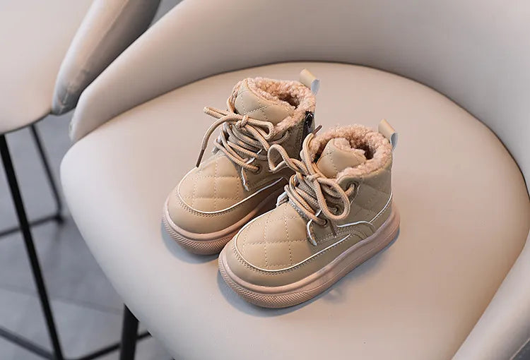 Indoor studio shot of kids plaid snow boots, displaying their attractive design and plush interior, winter fashion