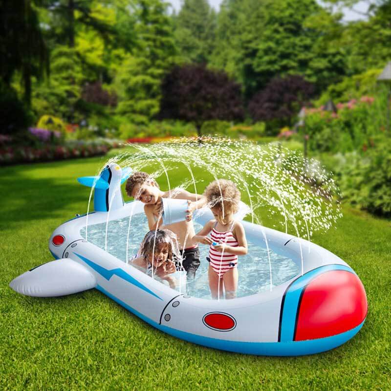 Kids playing in a vibrant blue inflatable splash pad sprinkler pool with water spraying, perfect for summer fun.