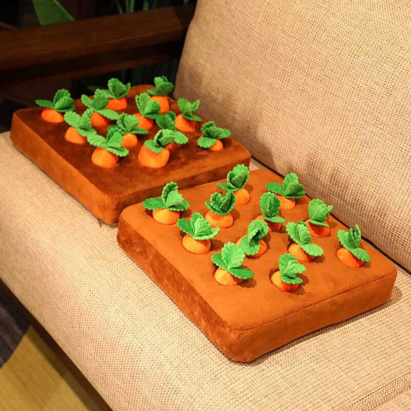 Close-up of soft plush carrots being 'harvested' from a plush base, an educational toy for kids