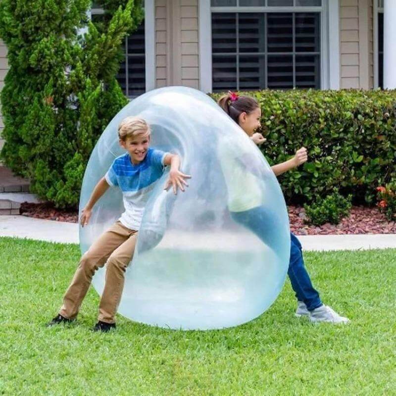 Durable, transparent giant inflatable bubble ball for active outdoor play by children.
