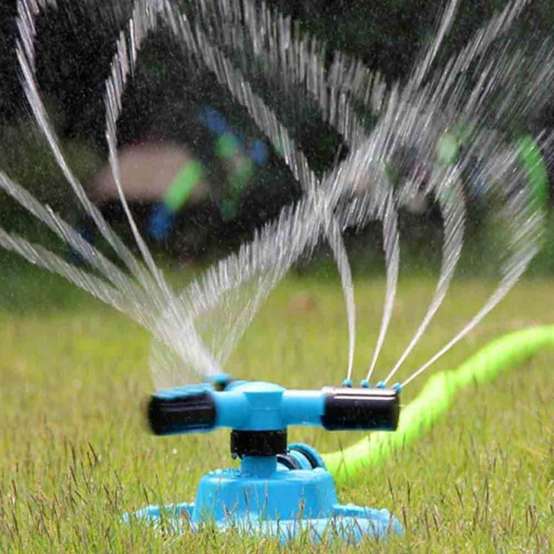 Colorful yard sprinkler toy engaging kids in active water play on a warm summer day.