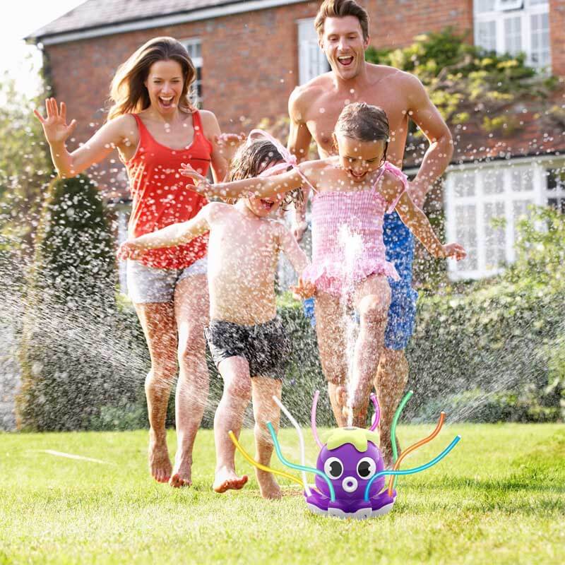 Colorful octopus water sprinkler toy showering kids in a green backyard.