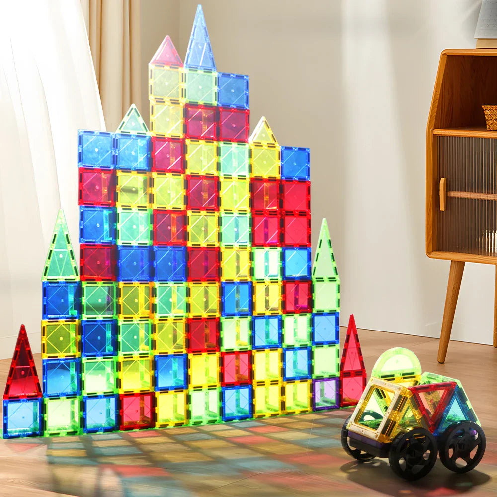 A diverse group of kids collaborating to build a large magnetic tile structure, fostering teamwork and imagination.