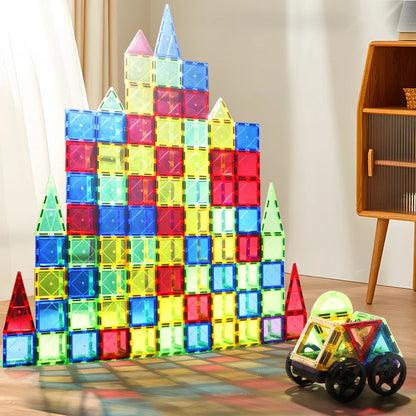 A diverse group of kids collaborating to build a large magnetic tile structure, fostering teamwork and imagination.