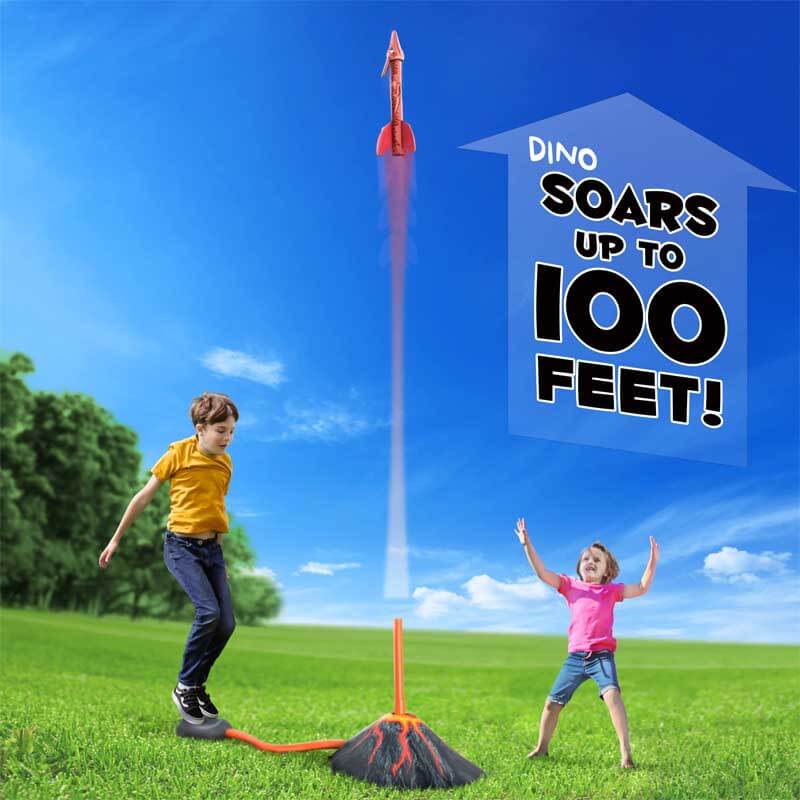 Close-up of a child's foot stomping on the launcher pad of a dinosaur rocket toy, preparing for blast-off.