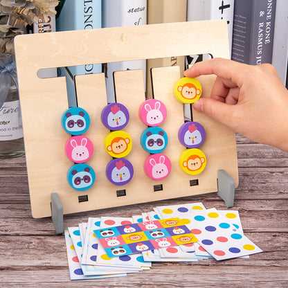Close-up of a child's hand picking a peg in the Wooden Memory Four-Color Chess game.