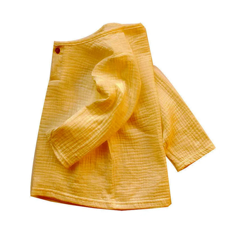 Close-up of the neckline and pleats on a kids' linen cotton blend t-shirt, elegant kids top