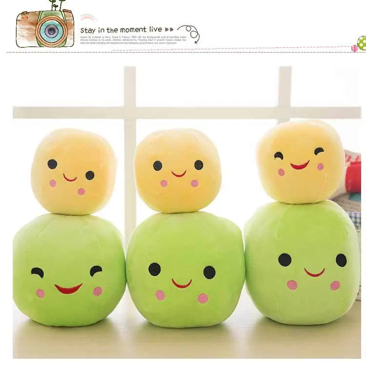 Plush Peas Doll sitting among other plush toys, showcasing its unique pea pod design
