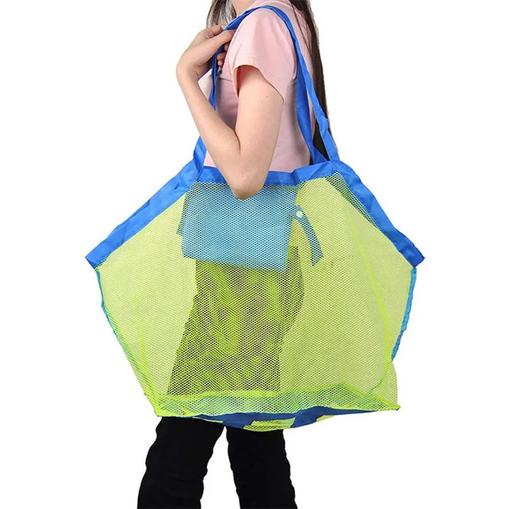 Foldable beach toy organizer bag with a bright green trim, empty