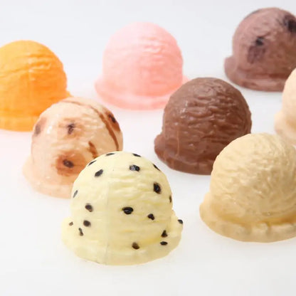 A child's hands carefully stacking colorful ice cream scoops onto a cone from the toy set