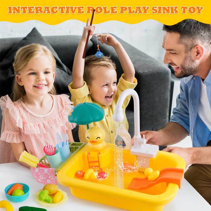 Child enthusiastically playing with a pretend kitchen sink toy, engaging in water play and role-playing.