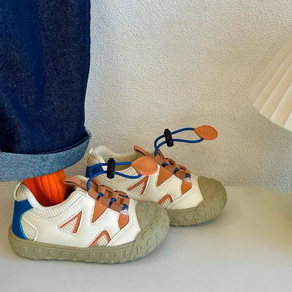 Close-up of the hook-and-loop fastener on a grey breathable mesh toddler shoe for easy wear.