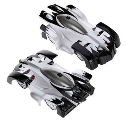 Child holding a black wall climbing stunt RC car, ready for anti-gravity adventures, a cool toy