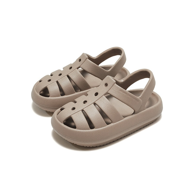 Pair of children's Roman sandals in navy blue, cushioned footbed, secure straps for active kids