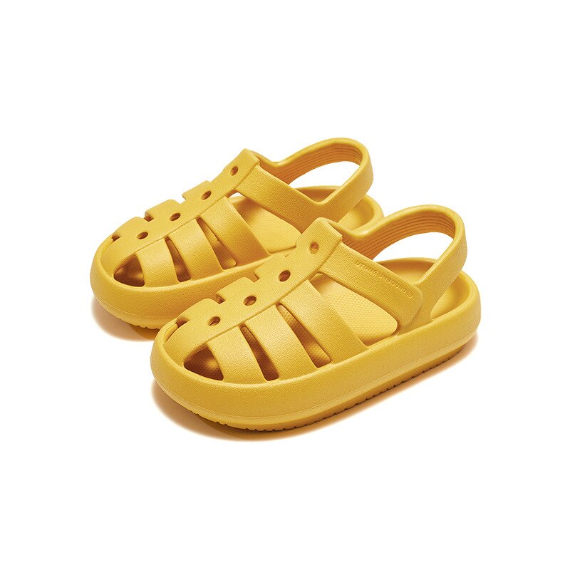 Boy wearing black Roman sandals with thick cushion, outdoor play in summer footwear