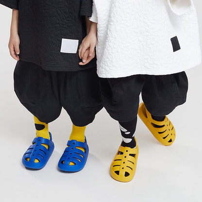 Side view of kids' Roman sandals, showing cushioned ankle strap and durable construction