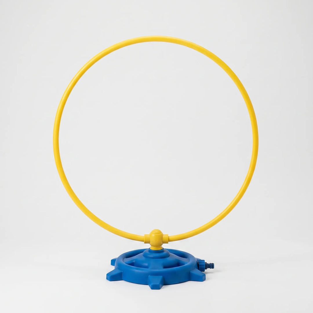 Vibrant rotating water sprinkler for kids' outdoor play, offering refreshing water fun in the backyard garden for summer.
