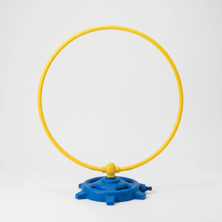 Vibrant rotating water sprinkler for kids' outdoor play, offering refreshing water fun in the backyard garden for summer.
